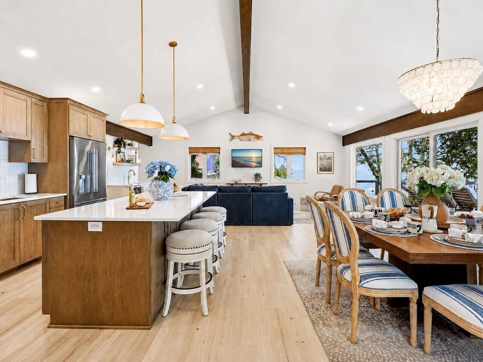 The spacious kitchen, dining area, and great room flow together so families can cook, eat, and relax without losing the lake view.