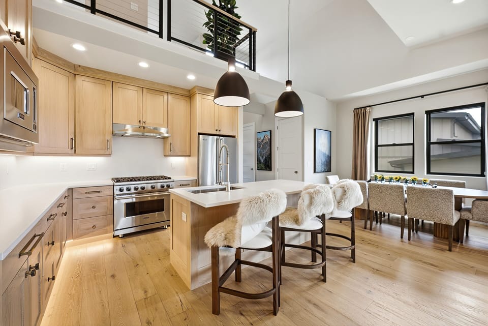 Chef's kitchen at Keetley Vista with professional-grade appliances, custom cabinetry, oversized island seating, and a seamless connection to the dining area.