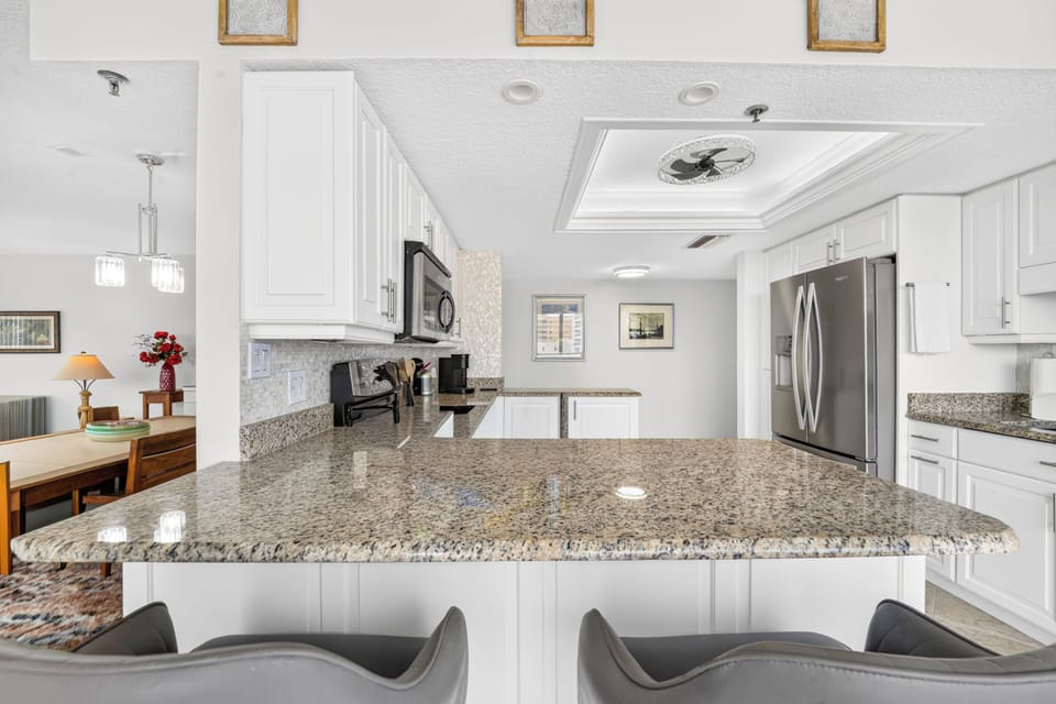 Your spacious kitchen invites with gleaming granite counters and a bright open layout—perfect for gathering over morning coffee or preparing a feast together.