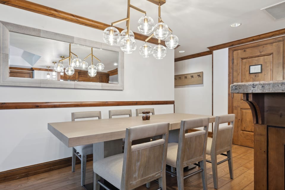 Bright dining area with seating for 6 and a statement modern chandelier