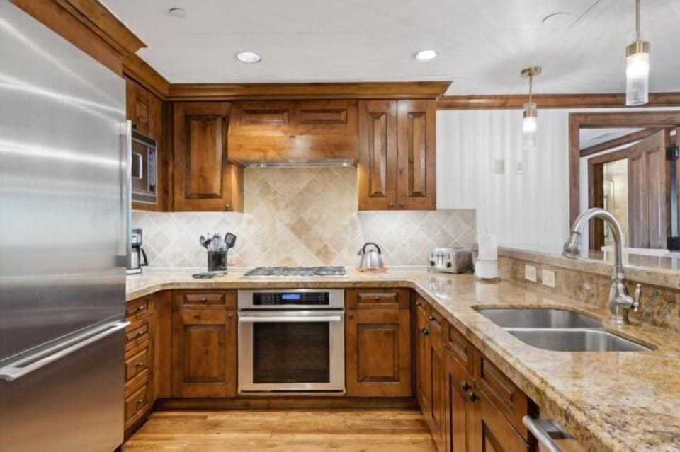 Upscale kitchen with granite counters and stainless steel appliances