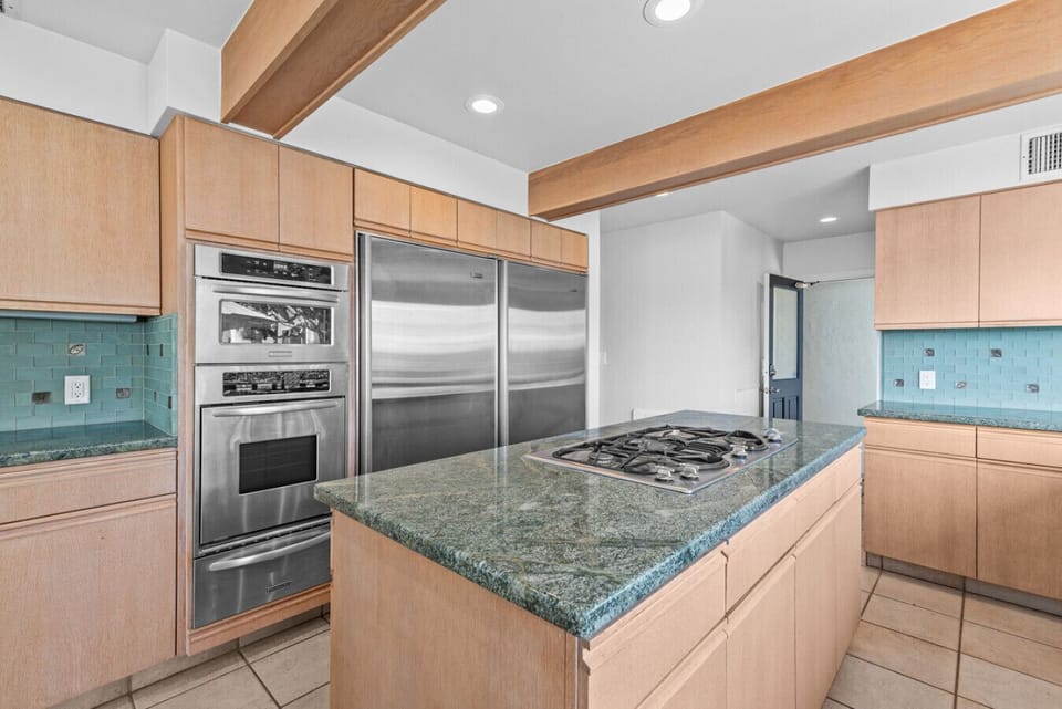 Cook with ease using stainless steel appliances, ample counter space, and a central island perfect for meal prep.