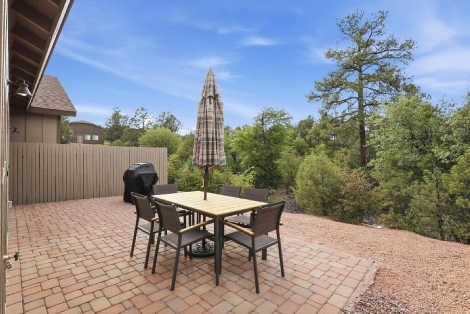 Private patio with outdoor dining, grill and peaceful views of surrounding pines