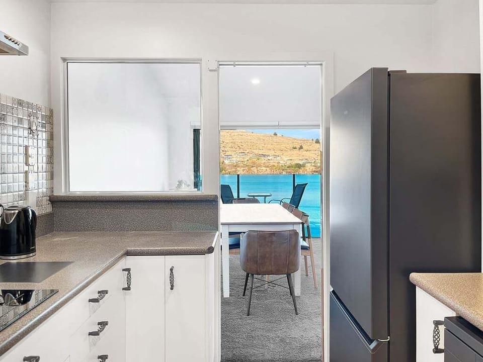Cook with a view in this well-appointed kitchen overlooking the dining area and lake beyond.
