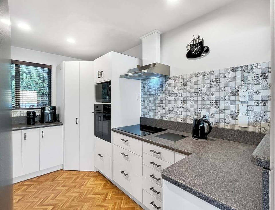 Bright and functional kitchen with modern appliances and generous bench space.