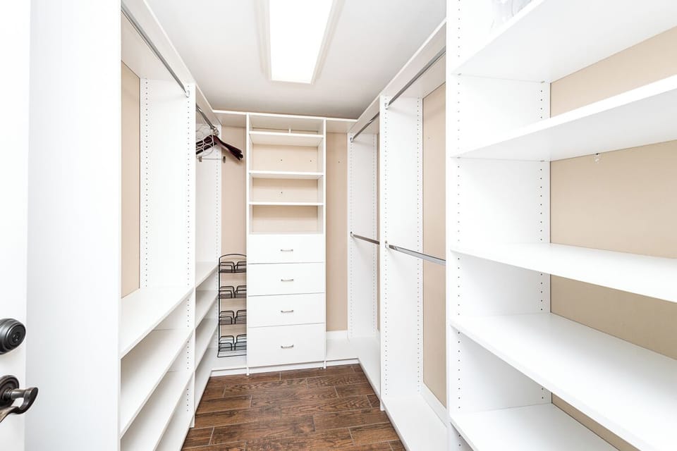 You'll love the spacious walk-in closet with custom shelving, drawers, and hanging rods—plenty of room to organize all your belongings and keep your vacation essentials neatly stored.