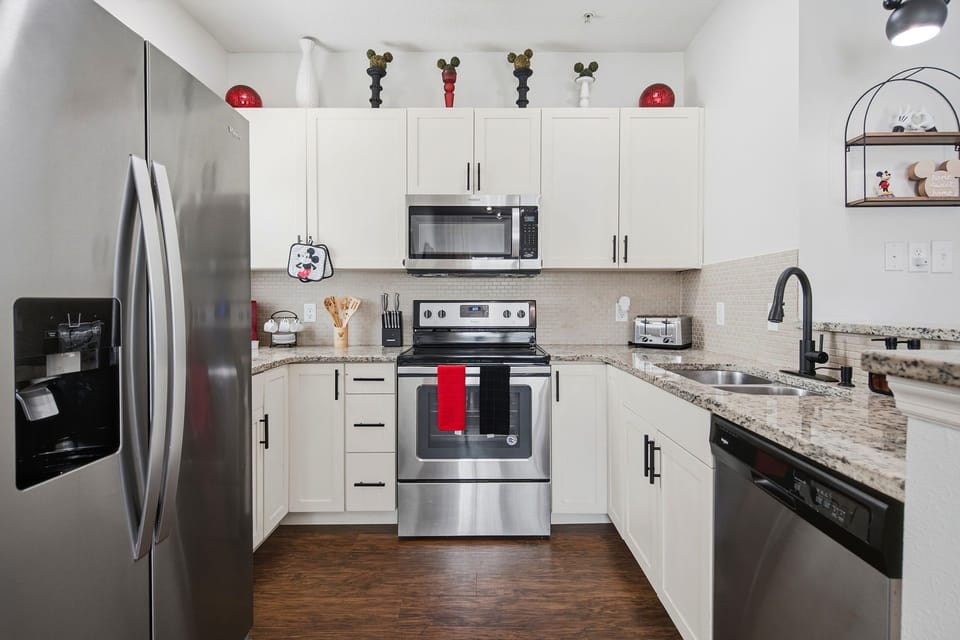 Bright modern kitchen with granite counters and stainless steel appliances