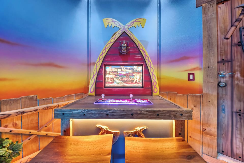 Enjoy a vibrant atmosphere with a stunning sunset mural that invites relaxation. Our rustic wooden table and unique decor provide a charming backdrop for quality time with friends and family in a warm, welcoming glow.