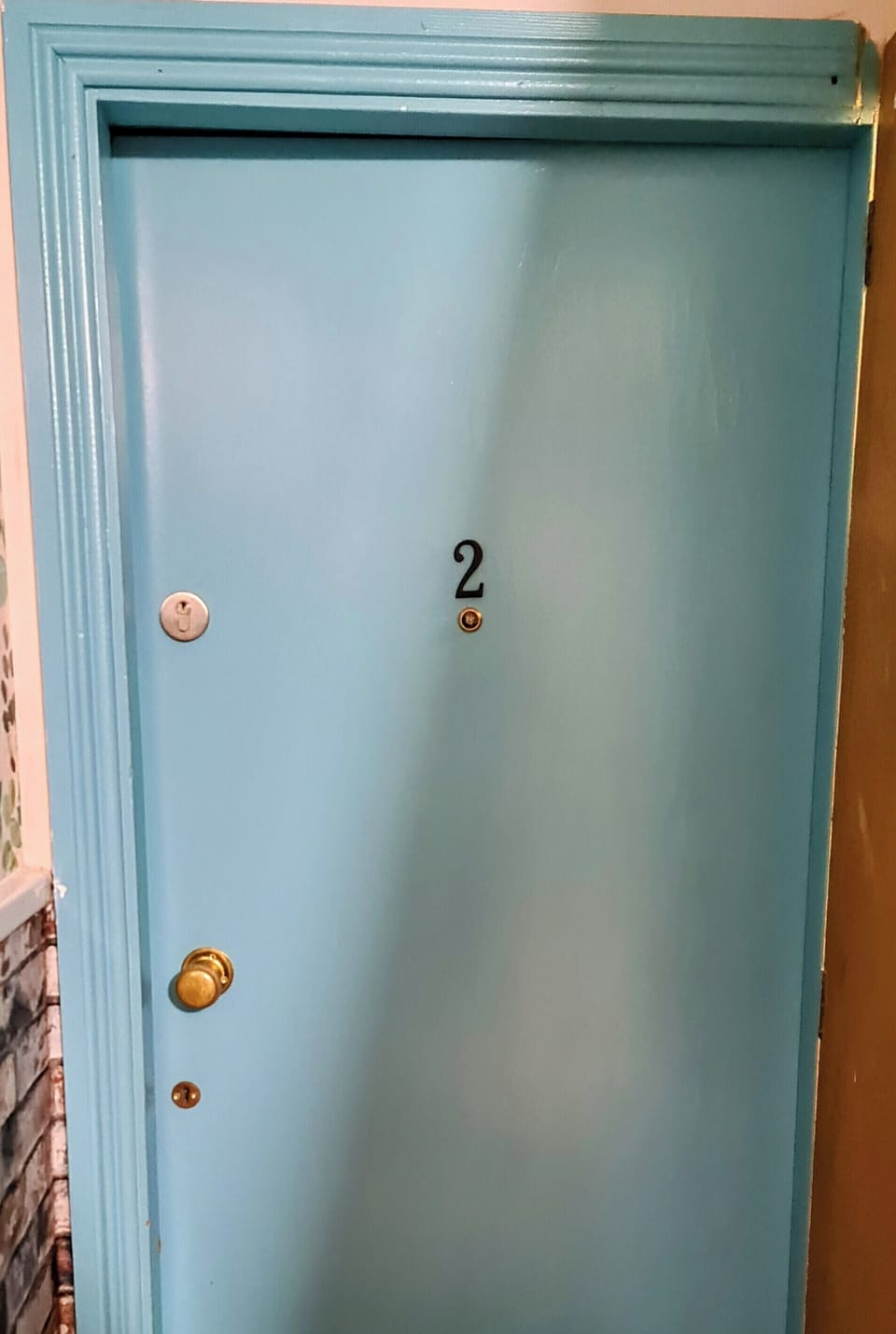 Charming blue entry door with a bright, welcoming first impression
