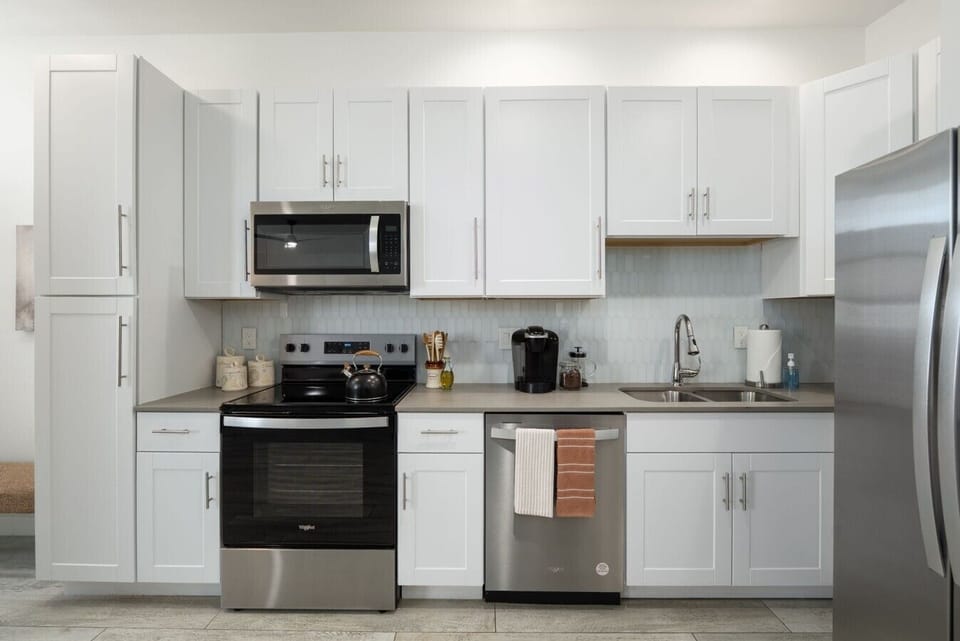 A chef-inspired space featuring sleek stainless steel appliances, spacious countertops, and a calming neutral palette.