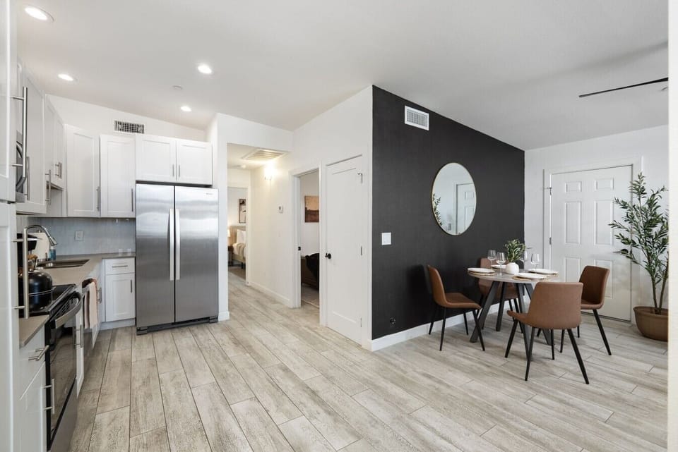 A stylish open-concept kitchen and dining space where modern design meets warm, inviting details.