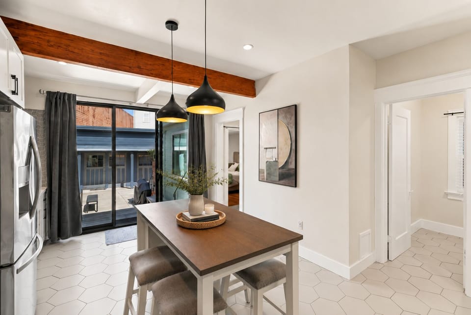 Bright modern dining area with patio access and warm designer touches