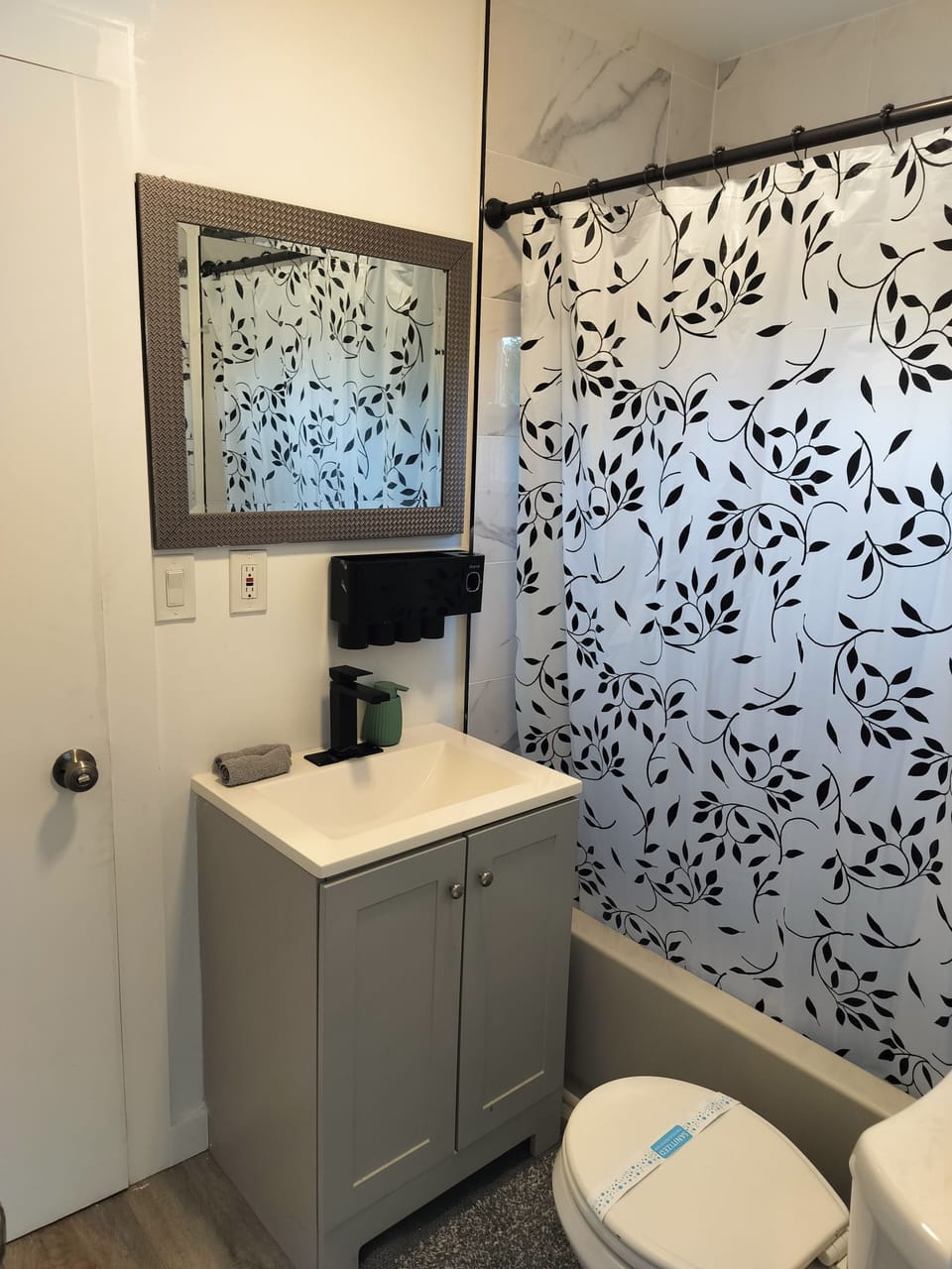 Bright, modern bathroom with stylish finishes and tub-shower combo