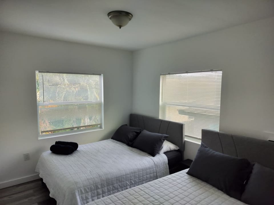 Bright double bedroom with two cozy beds and plenty of natural light