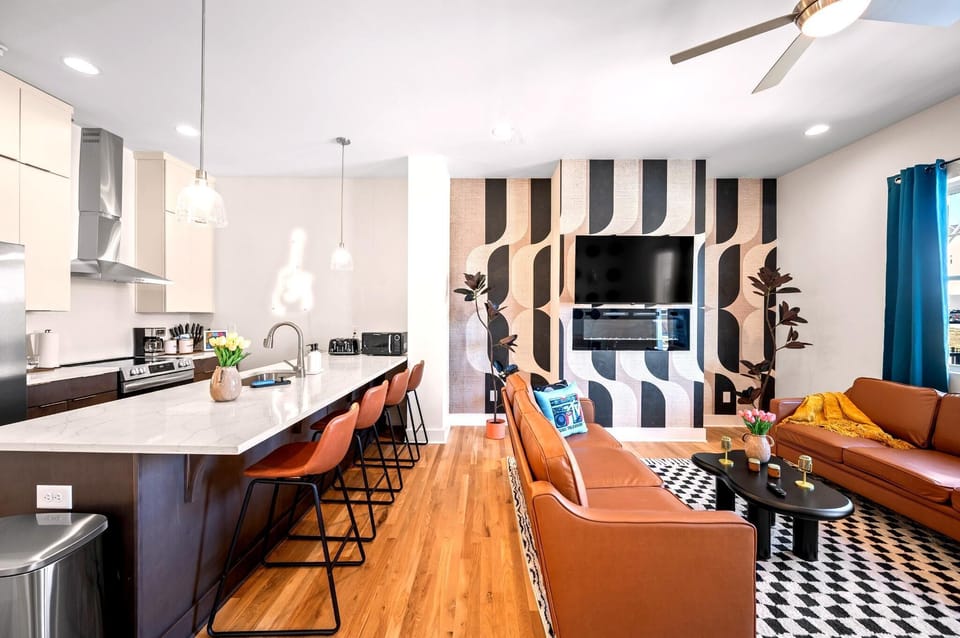 The open-concept kitchen keeps everyone connected, with bar seating, generous prep space, and an easy flow into the dining and living areas.