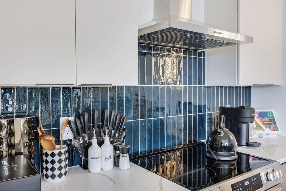 Modern finishes, striking blue tile, and everything you need for cooking make this kitchen as stylish as it is functional.
