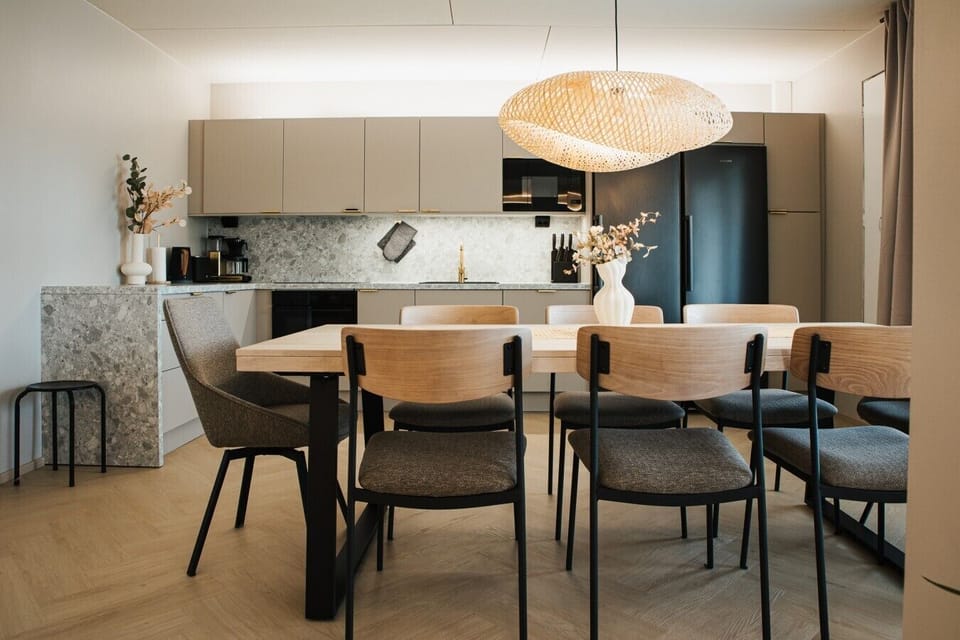 A well-lit dining corner with a wooden table, ideal for shared meals.