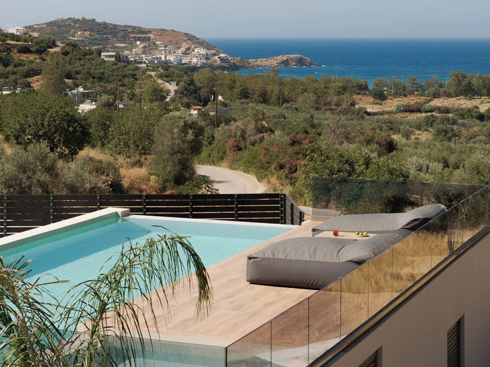 The 45m² infinity pool frames refreshing swims against distant sea views.