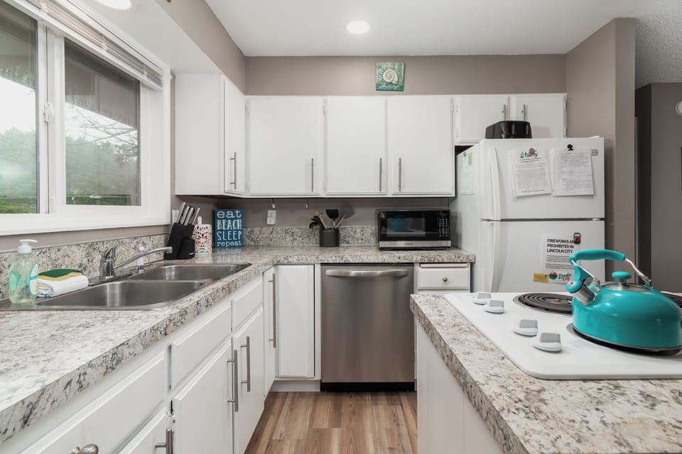 Your fully equipped kitchen awaits, featuring granite countertops, stainless appliances, and everything you need to prepare meals at home. Bright windows invite natural light while you cook.