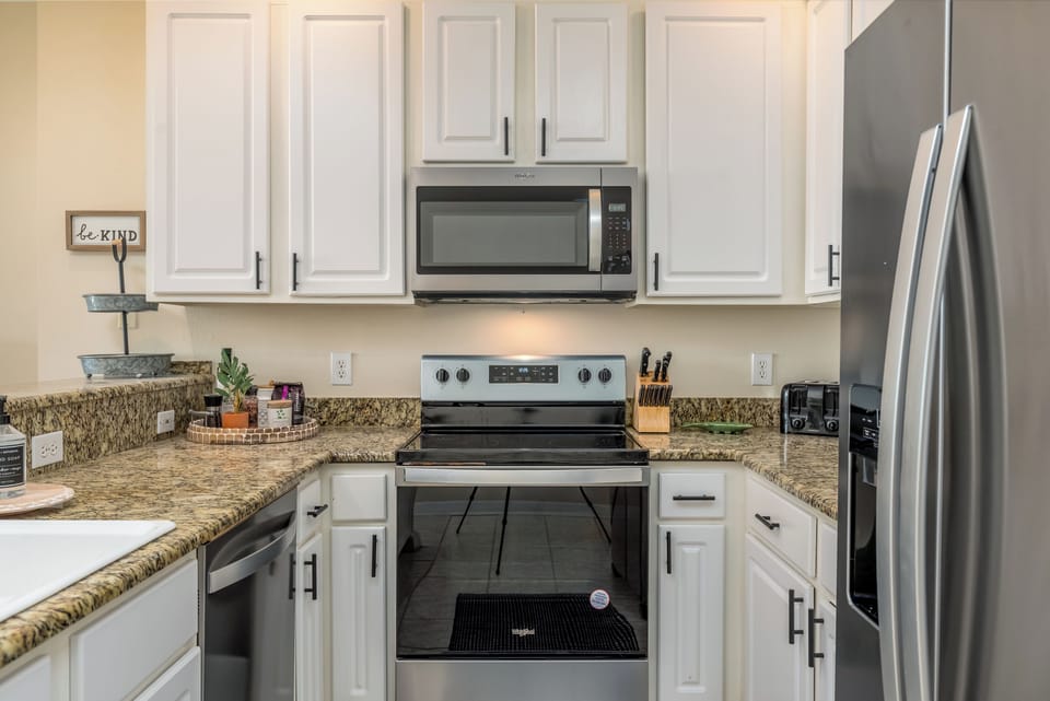 Your fully-equipped kitchen awaits with granite countertops, stainless steel appliances, and everything needed for home-cooked meals.