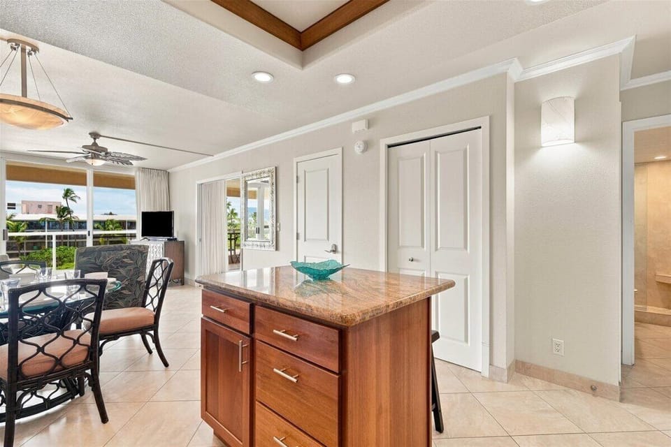 Gather around the kitchen island and enjoy effortless flow into your living and dining spaces, with ocean breezes just beyond the lanai doors.