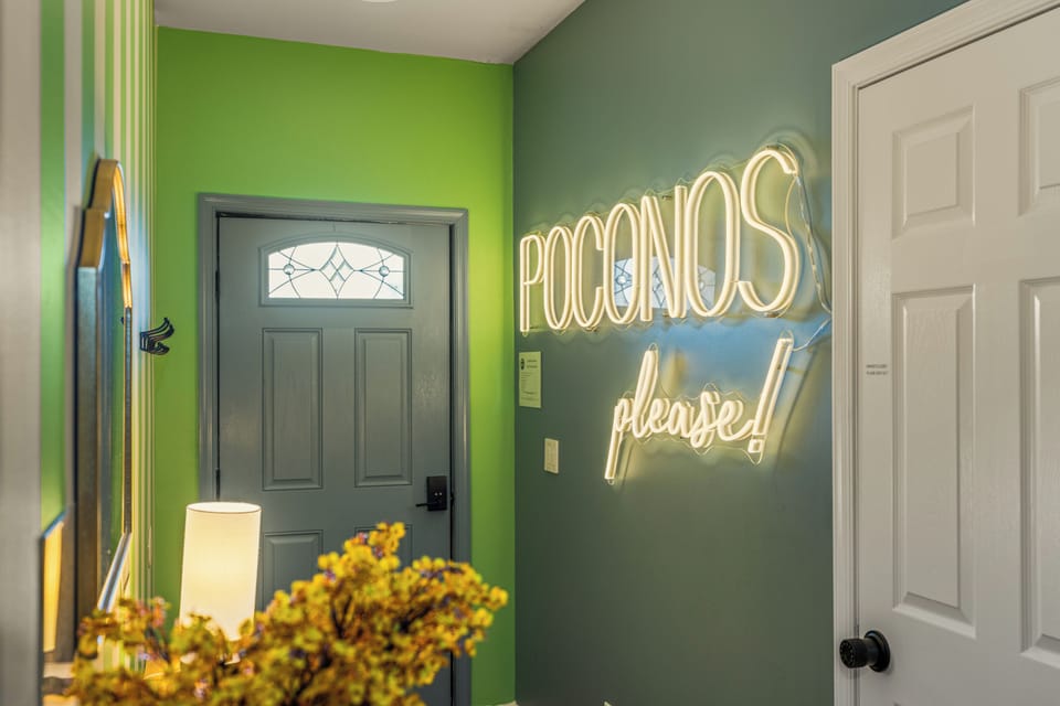 Bright, playful entryway with neon Poconos charm