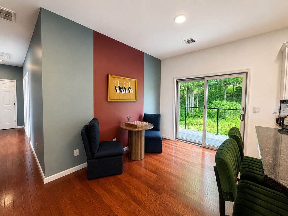 Cozy dining nook with deck access and serene wooded views