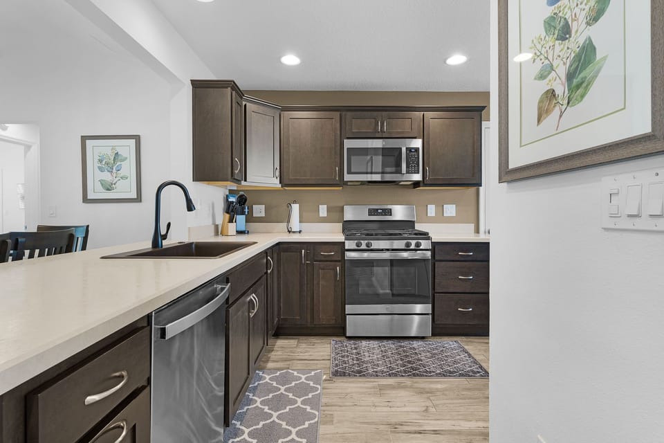 Step into your private kitchen where every detail has been chosen with you in mind. Rich wood cabinetry, modern stainless appliances, and expansive countertops create the perfect backdrop for preparing meals or lingering over morning coffee.