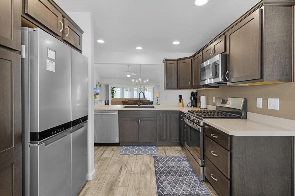Your fully equipped kitchen features stainless steel appliances, generous counter space, and rich cabinetry—perfect for preparing meals and gathering with loved ones during your stay.