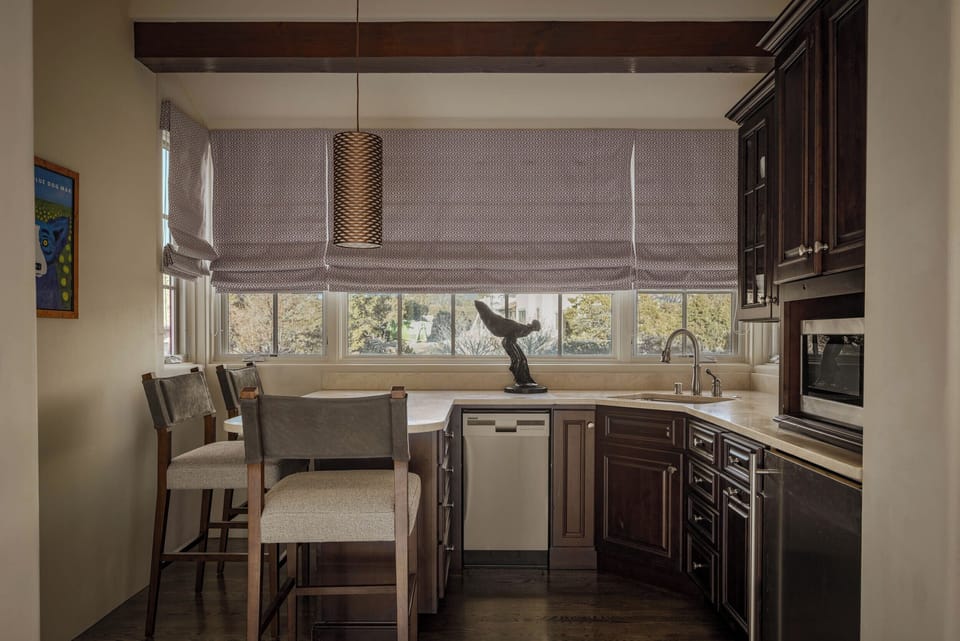 Your gourmet kitchen awaits with rich wood cabinetry, modern appliances, and a cozy breakfast nook overlooking peaceful garden views.