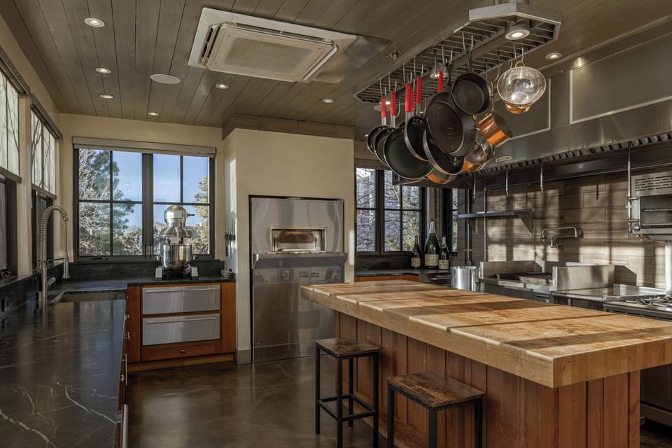 Create culinary masterpieces in this stunning chef's kitchen featuring professional-grade appliances, butcher block island, and panoramic windows flooding the space with natural light.