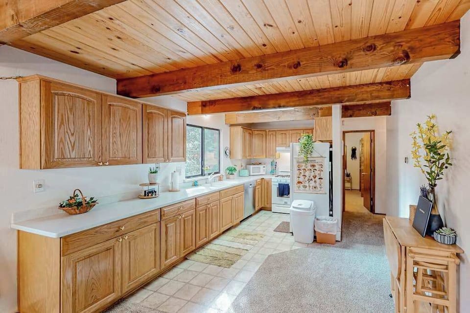This cozy kitchen at Forest Retreat in Arnold, CA, features charming rustic decor, perfect for preparing your group's favorite meals.