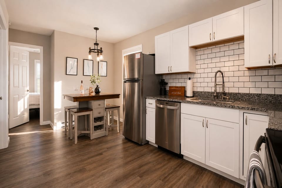 Bright modern kitchen with stainless appliances and cozy dining nook
