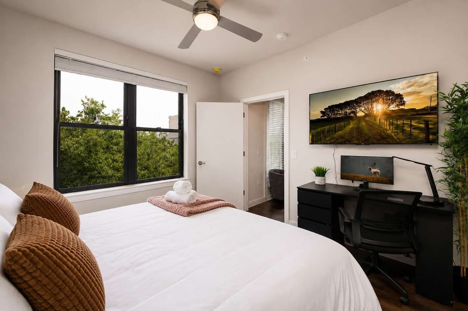 Comfortable king bedroom featuring Smart TV and a work-friendly desk.