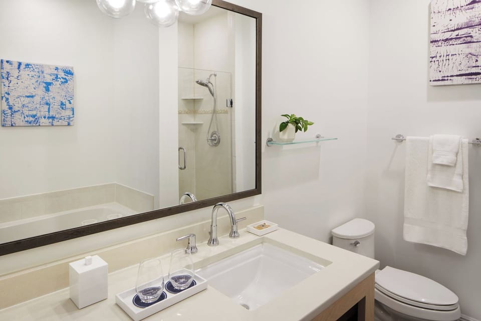 Settle into a spacious bath with mirror, sink, and storage.