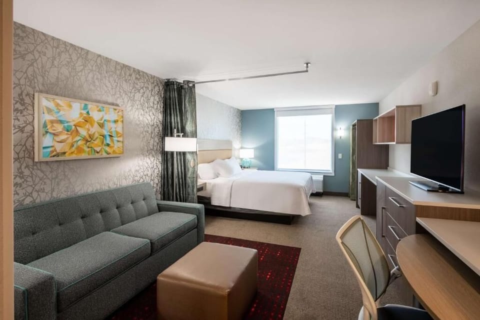 Settle into a spacious suite with sofa seating and plush bed.