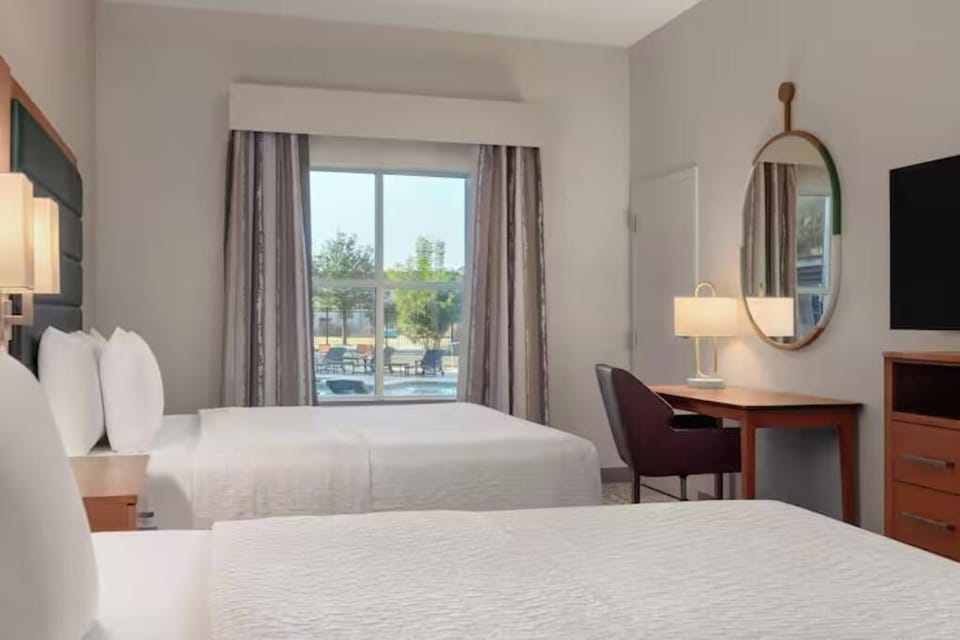 Settle in with two plush beds and a bright window view.