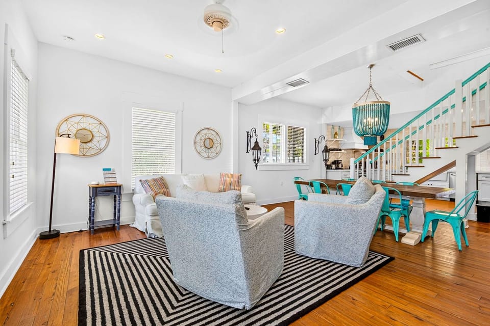 Bright open living space with hardwood floors and stylish dining area