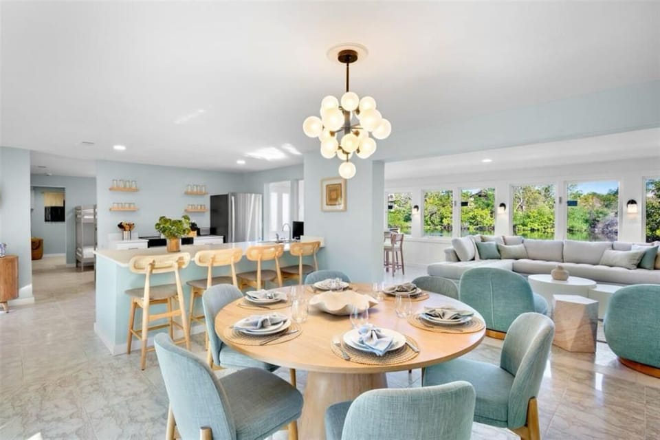 Bright open-concept living with stylish dining, island seating, and garden views