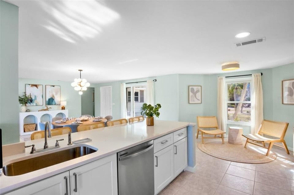 Bright open kitchen, dining space, and sunny sitting nook