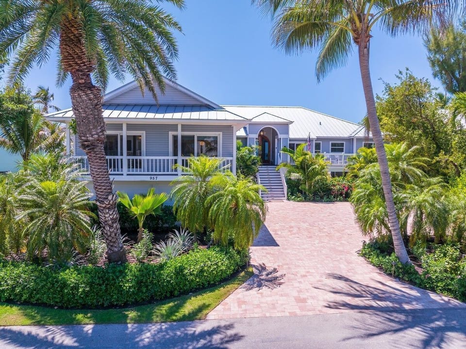 The property's exterior sets the tone for a single-story coastal retreat.