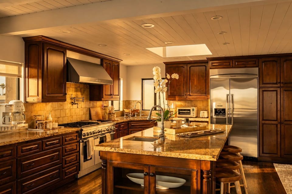 Warm evening light brings out the kitchen’s custom finishes, creating an inviting space for cooking, gathering, and entertaining.