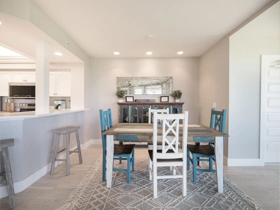 The dining area is set with table seating for shared meals.