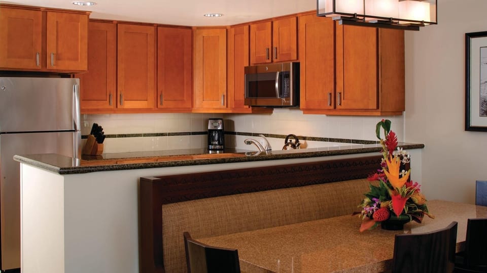 Warm full kitchen with stainless appliances and cozy dining nook