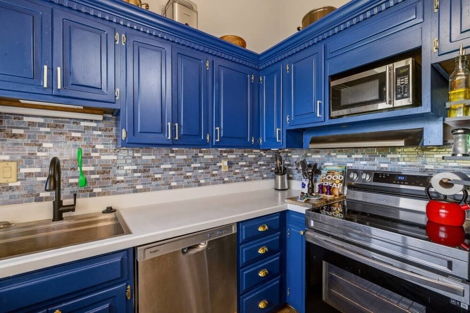 Well-appointed kitchen with a full-size range, microwave, dishwasher, generous storage, and quality cookware for effortless home cooking.