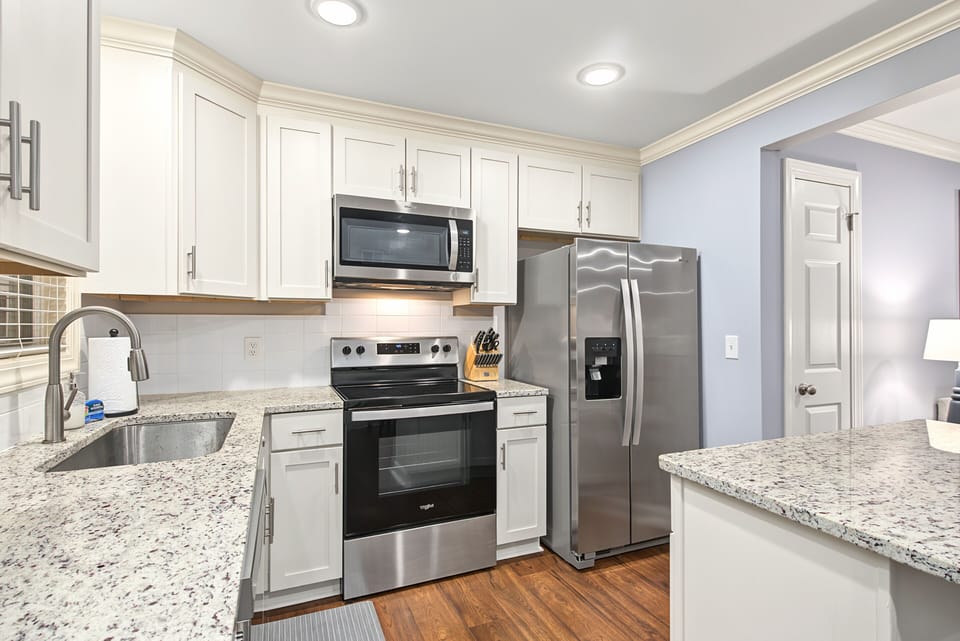 Kitchen with granite counters and stainless appliances.  Regularly replaced water filter in fridge for clean water and ice.
