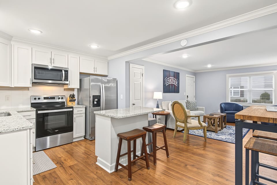 Bright open-concept kitchen and lounge with breakfast bar seating