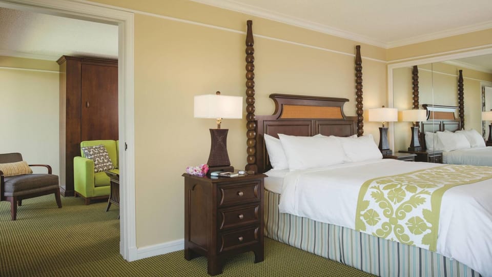 Spacious king bedroom with elegant wood accents and cozy sitting area