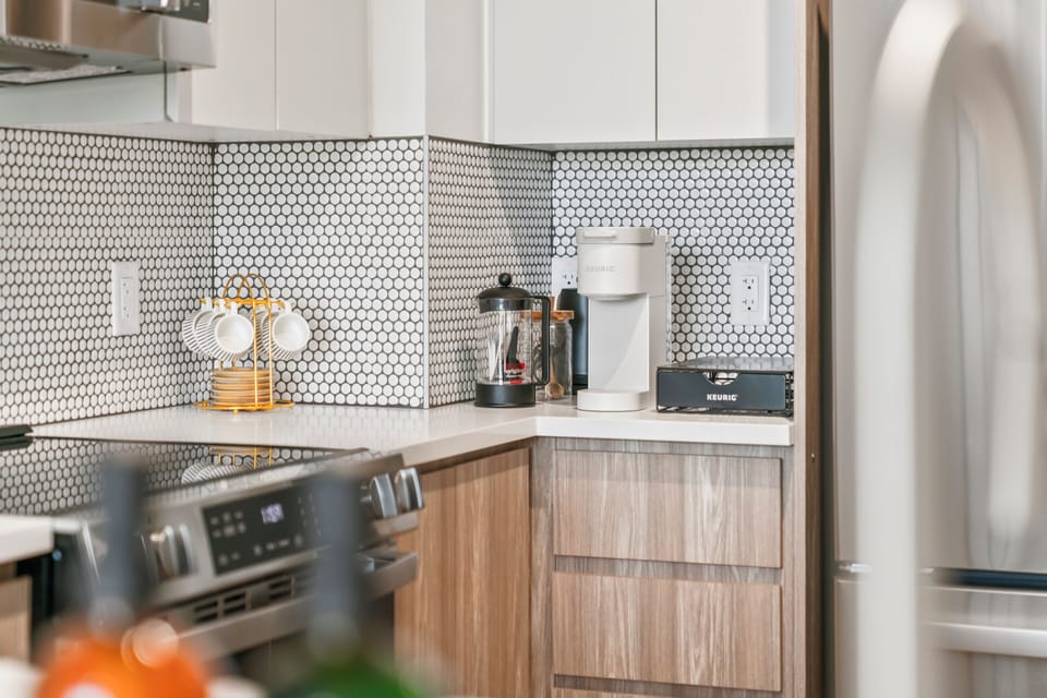 Modern kitchen with stylish tile backsplash and ready-to-use coffee bar
