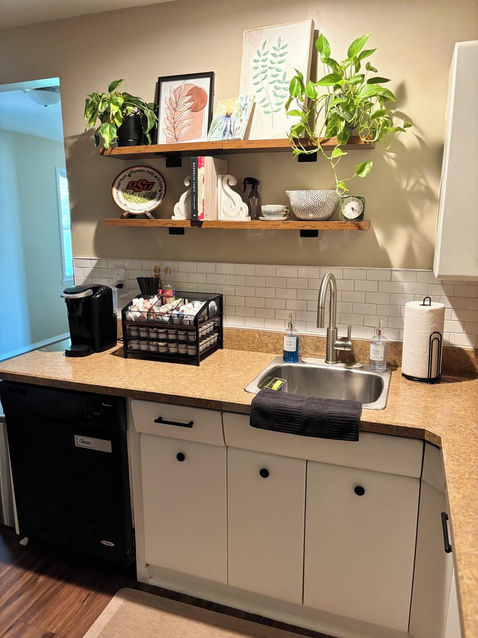 Cozy kitchenette with coffee station, open shelving, and stylish decor